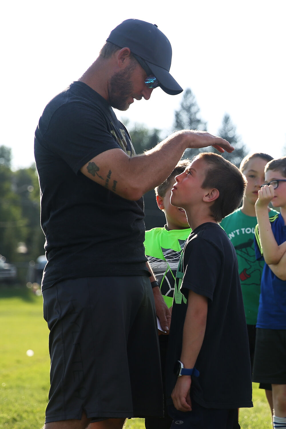 Head coach Parker Ruby pats the head of Tyrus Connors